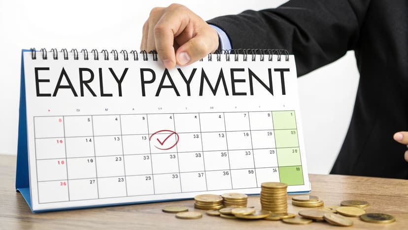 An illustration showing a hand dropping a coin into a piggy bank, symbolizing savings from early payment discounts.