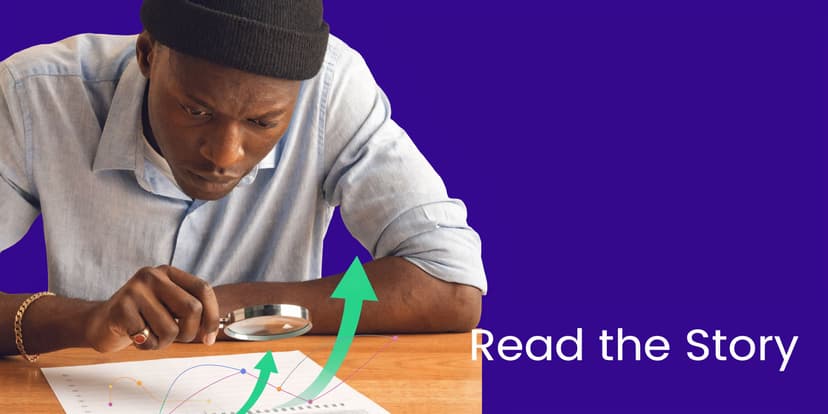 A focused man wearing a beanie examines a financial chart with a magnifying glass to understand data.