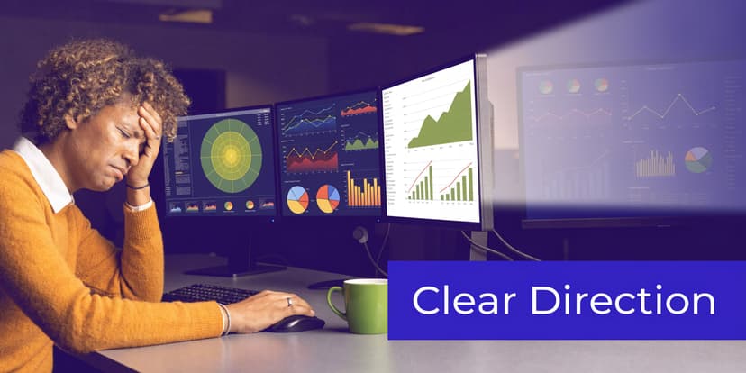 A stressed professional woman sitting at a desk with multiple monitors displaying complex charts and data analytics.